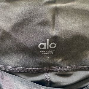 Black, shiny, Alo Yoga leggings.